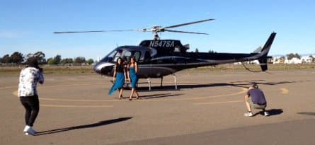 A photographer taking photos of the Bella twins in front of a black helicopter