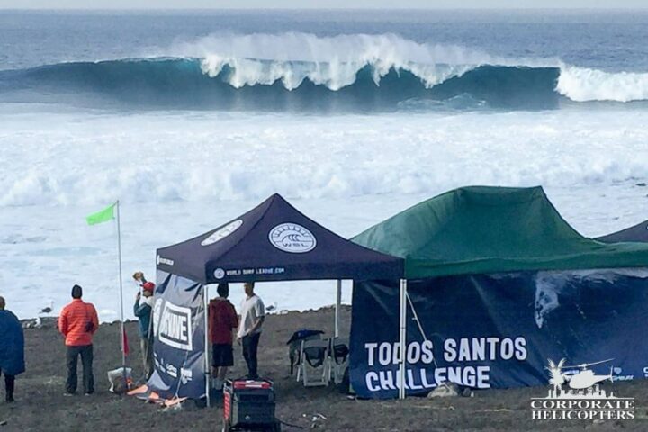 Specatators and event staff view a big wave at the Todos Santos Challenge