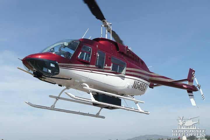 Helicopter in flight with LiDAR mapping equipment attached to the bottom