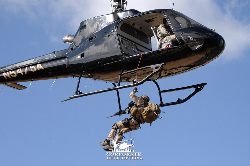 Man rappeling from a helicopter in flight