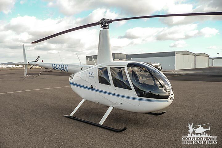 White 2007 Robinson R44 Raven II helicopter on an airfield