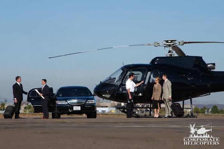 A helicopter, a limousine, men and women in suits