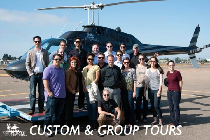 A group of 20 people pose in front of a helicopter. Text reads: Custom & Group Tours