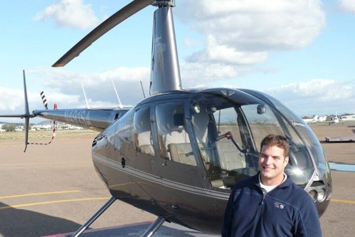 Man stands next to helicopter