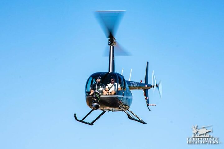 Helicopter in flight, a Shotover B1 Camera is attached to the nose