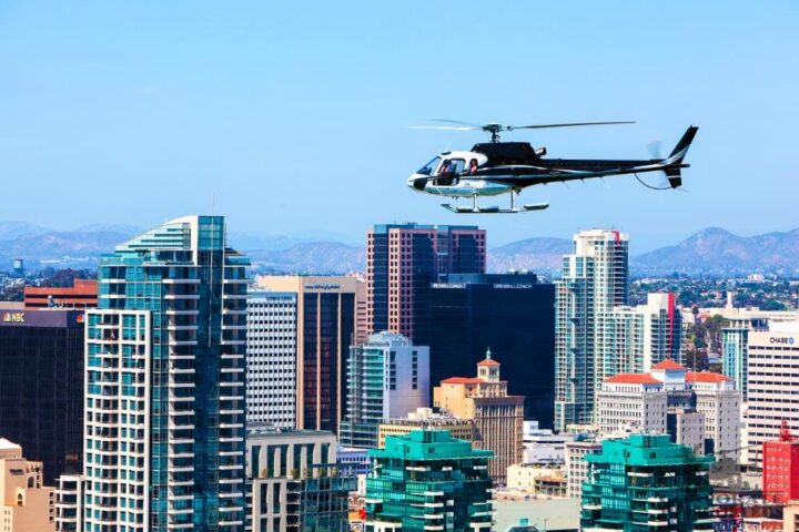 Helicopter flies over Downtown San Diego skyline.