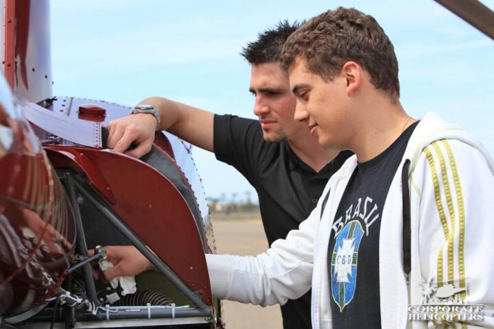 Student and instructor inspect a helicopter prior to takeoff