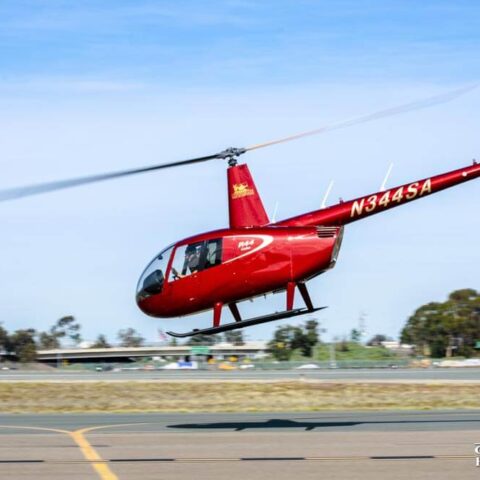 A Robinson R44 helicopter taking off