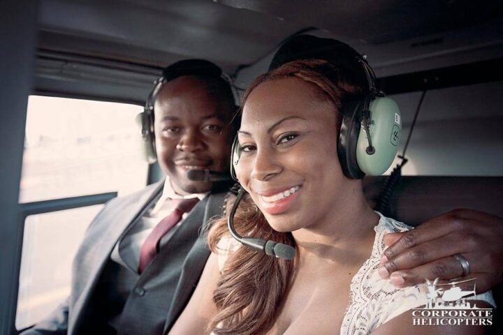 Couple pose in helicopter cabin