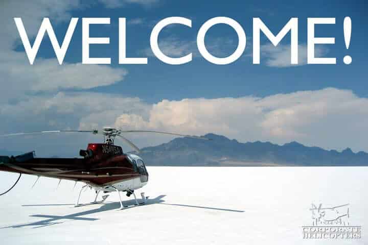 Helicopter landed in the snow. Text reads: Welcome