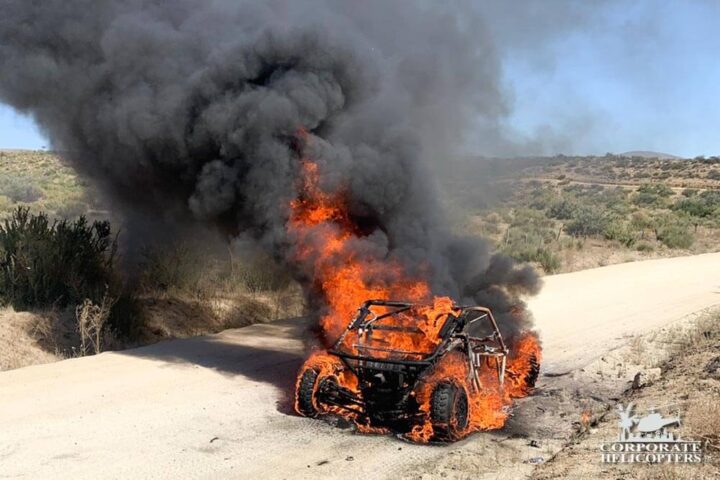 An off-road race car engulfed in flames
