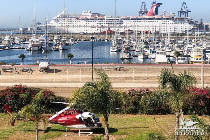 Helicopter parked at Corona Hotel in Ensenada. Cruise ship &harbor is prominent in the background