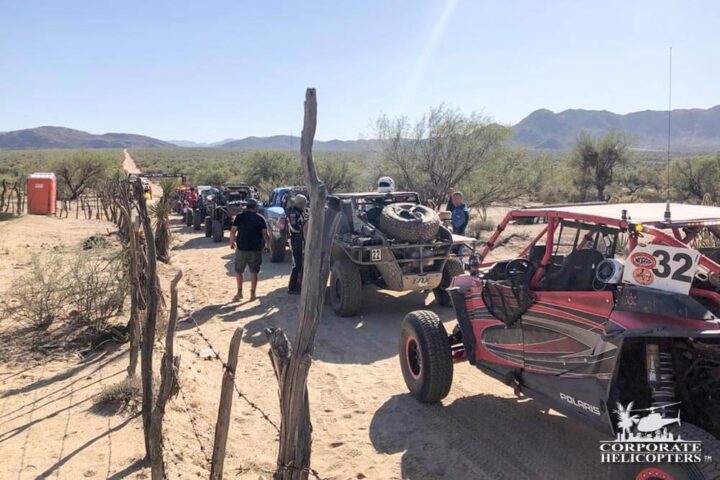 Off road race vehicles lined up in the desert