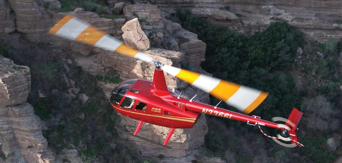 R66 helicopter flies over a canyon