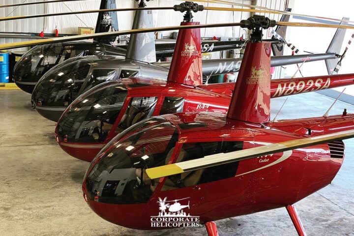 A row of 4 Robinson R44 helicopters at Corporate Helicopters of San Diego.