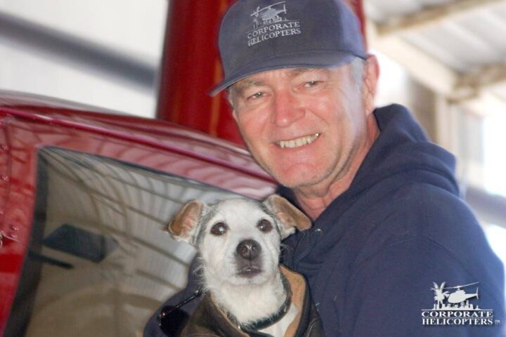 Captain Terry Frost smiles next to a dog